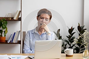 Sleepy bored businesswoman yawning at workplace feeling deprived in office