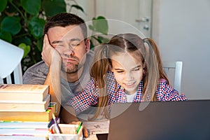 Sleepy dad helps daughter online lessons on laptop