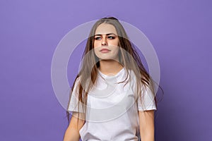 Sleepy girl, wearing casual tshirt bored, restless and sleepiness, feels weak bored, standing over purple background. Chronic
