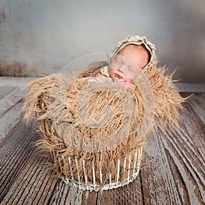 Sleepy infant in basket with blanket like weat