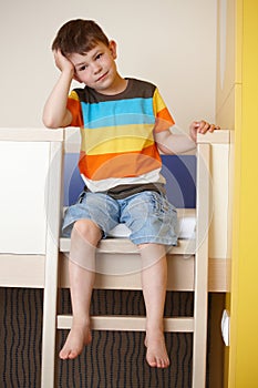 Sleepy little boy on bunk bed