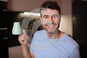 Sleepy looking man holding coffee cup upside down