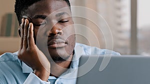 Sleepy tired african man office male dreamer businessman has sleeping problem napping rest at desk american lazy student