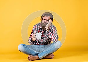 Sleepy tired guy. he is taking a coffee break. Handsome mature guy drinking from cup. Hold cup of coffee or tea