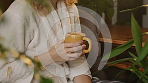Sleepy tired woman holds coffee mug