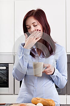 Sleepy woman drinking coffee