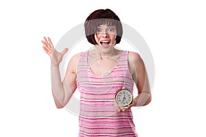 Sleepy woman is holding alarm clock