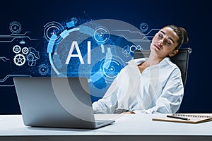 Sleepy young businesswoman at desk with laptop and glowing AI hologram on blue background. Artificial intelligence, robotics and