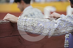 The sleeve of the jacket of a bullfighter.