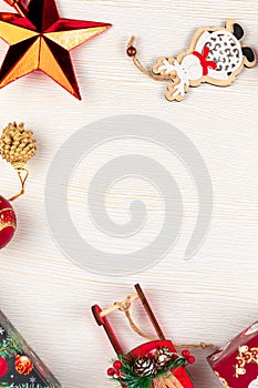 Sleigh of santa claus, christmas tree branch, christmas toys, pine cone and boxes with gifts on a white background