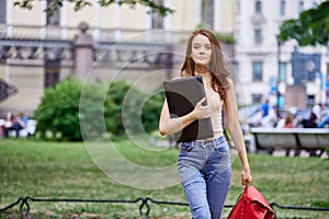 Slender 18 year old student came to park with laptop.