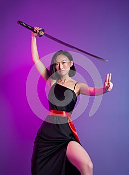 slender Asian woman in a black dress with a katana in her hand image of a samurai on a neon background