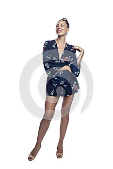 Slender beautiful woman in a blue elegant mini dress. Lady in high heels. Fashion & Style. Isolated on a white background.