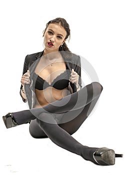 Slender brunette girl removes a business suit undressing