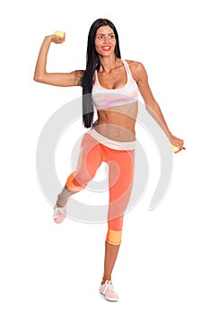 Slender fitness girl throws a tennis ball