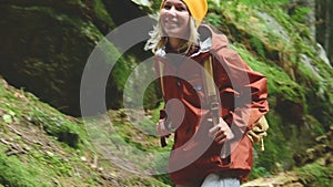 Slender girl goes along the path to the top in the coniferous forest. Tourism in the Caucasus Reserve. Will approach the