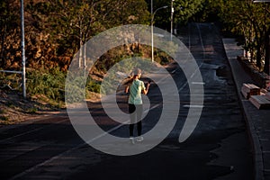 Slender girl in sportswear is jogging, holding smartphone in hands. Business woman talking on phone