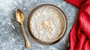 a slender golden bowl brimming with creamy white kheer, accompanied by a gleaming gold spoon, resting atop a crimson