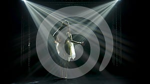 Slender high woman in greek greece goddes dress and wreath high fashion. Dances gracefully and performs smooth movements