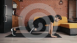 Slender man doing running plank exercise at home