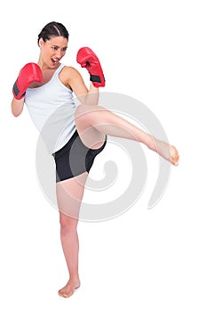Slender model with boxing gloves kicking