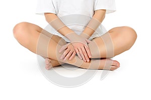 Slender naked legs being massaged