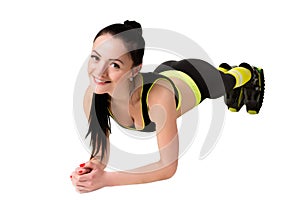 Slender smiling girl in kangoo jumps shoes doing plank exercise.