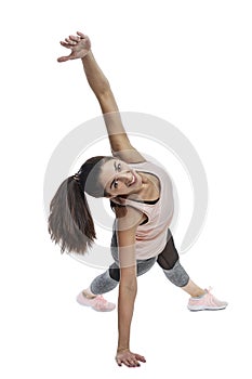 Slender smiling woman in sportswear delvet doing exercises. Beautiful brunette in a pink top. Activity, energy and health.