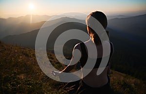 Slender woman doing yoga on fresh air.