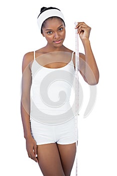 Slender woman holding measuring tape