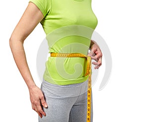Slender woman measuring her waist
