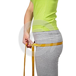 Slender woman measuring her waist