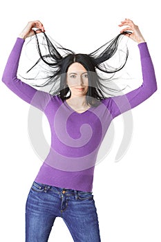 Slender woman raises hair hands isolation