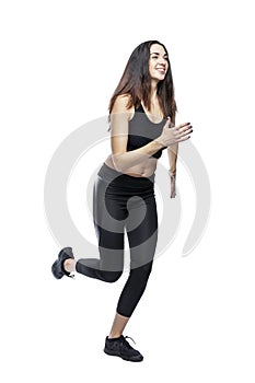 A slender woman in sportswear does exercises. Beautiful brunette in black leggings and top. Health, sports and slimness. Full