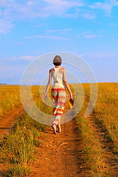 Slender woman to walk on the earth road