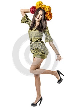 Slender young cheerful girl brown hair dances with a bouquet of colorful flowers on her head