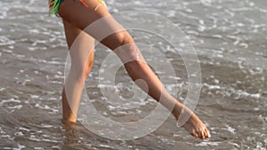 Slender young girl on the coast