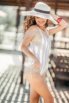 A slender young woman in a bikini fashion model in an elegant, sporty bathing suit on vacation