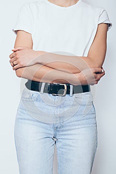 Slender young woman wearing blue high waist jeans