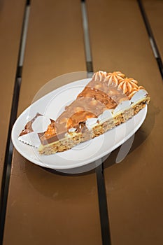Slice of almond cake in white plate