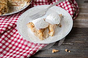 Slice of apple pie with whipped cream on top.