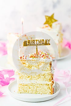 Slice of birthday cake with gold decoration