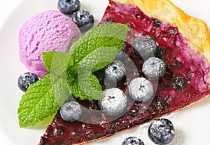 Slice of blueberry tart with ice cream