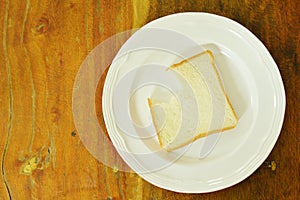 Slice bread bite on white plate