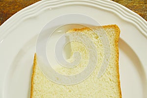 Slice bread bite on white plate