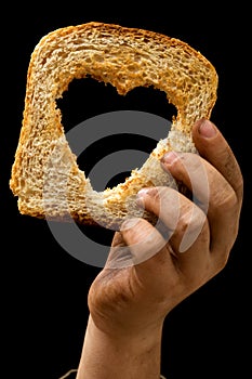 Slice of bread in child's dirty hand