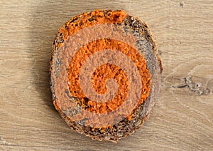 Slice of bread with Filet americain on wooden background