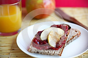 Slice of bread with jam and apples and cinnamon