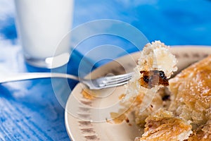 Slice of burek on the fork with blurred background