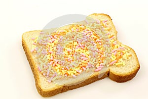 Slice of buttered white bread with colorful fruit